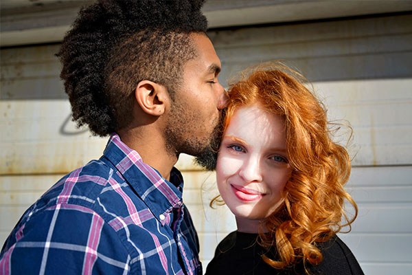 biracial couple kissing