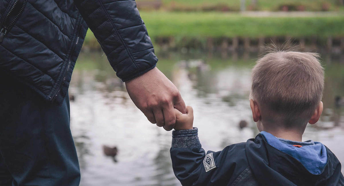 dad holding his son